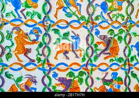 The colorful Azulejos (glazed tiles) on the walls of Alcazar Gardens with images of mythological creatures and geometrical patterns, Seville, Spain Stock Photo