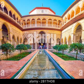 SEVILLE, SPAIN - OCTOBER 1, 2019: Patio de las Doncellas is the most impressive courtyard with carved arcades and narrow pond with amazing reflection, Stock Photo