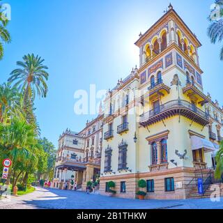 SEVILLE, SPAIN - OCTOBER 1, 2019: Panoramic view on Hotel Alfonso XIII, one of the most luxurious places in the city with cozy garden surrounding it, Stock Photo