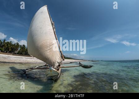 sailing with a sail boat in Kenya, Zanzibar and Maldives in beautiful crystal Turquoise water on white sand tropical beach. Traditional fishing wooden Stock Photo