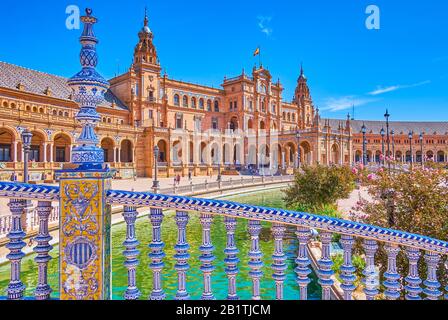 SEVILLE, SPAIN - OCTOBER 1, 2019: The pleasant walk on Plaza de Espana in surrounding of amazing examples of Andalusian Mudejar style architecture, Oc Stock Photo