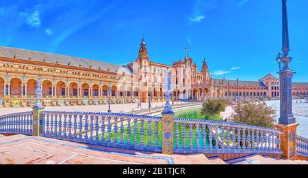 SEVILLE, SPAIN - OCTOBER 1, 2019: Panoramic view on the beautiful Andalusian style ceramic handrails on the bridge over canal in Plaza de Espana, on O Stock Photo