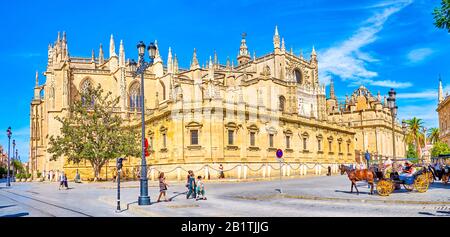 SEVILLE, SPAIN - OCTOBER 1, 2019: The view on the pearl of medieval Andalusian architecture, the Seville Cathedral from Avenida de la Constitucion, on Stock Photo