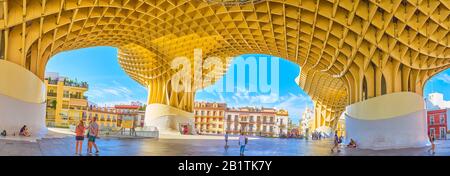 SEVILLE, SPAIN - OCTOBER 1, 2019: The large area under the main construction of Metropol Parasol is the popular place among local youth, October 1 in Stock Photo