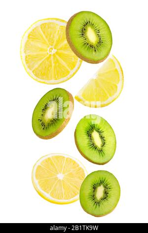Falling kiwi and lemon fruits isolated on white background. Stock Photo