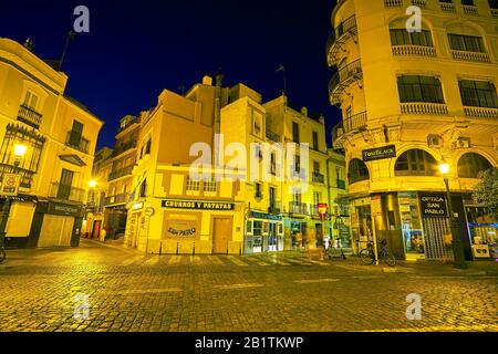 SEVILLE, SPAIN - OCTOBER 1, 2019: The closed stores in silent night streets deep in the heart of old town, on October 1 in Seville Stock Photo
