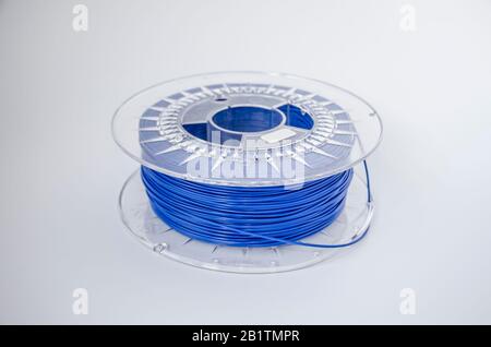 Plastic for 3D printing. Blue plastic filament, red ABS/PLA coil for 3d printer on white background, isolated Stock Photo