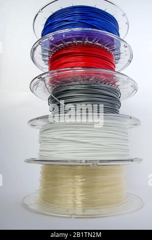 Plastic for 3D printing, different colors plastic filament, ABS/PLA coil for 3d printer on white background, isolated Stock Photo