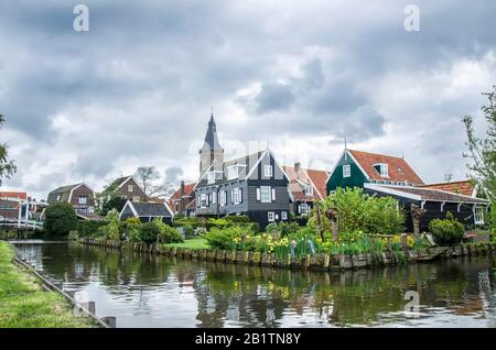 View of canal, bridge and traditional wooden fishing houses in waterland village Marken, Netherlands. Traditional Holland symbols canal, wooden houses Stock Photo