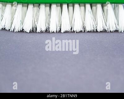 Clothes brush with white bristles on a gray background. Stock Photo