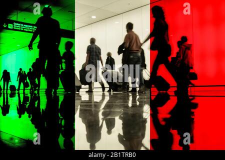 People walking through airport terminal with flag of Italy overlayed. Italy, travel, Coronavirus... concept Stock Photo