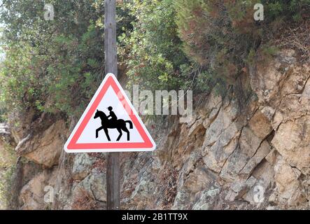 road sign with the symbol attention to the crossing of horses near an equestrian center Stock Photo