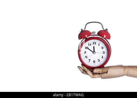 Wooden hand holding retro red alarm clock isolated on white background. Time management concept, business planning Stock Photo