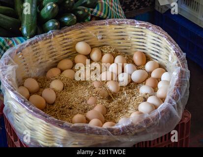 close up of basket of brown eggs in the market Stock Photo