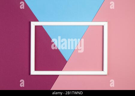 Geometry background minimal concept. Multicolored paper with empty picture frame. Creative flat layout with copy space. Stock Photo