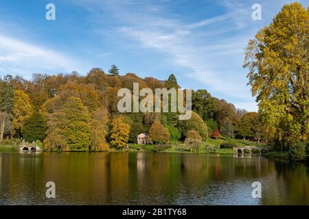 View of the autumn colours around the lake at Stourhead gardens in Wiltshire. Stock Photo