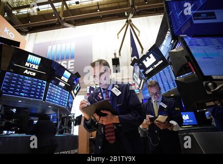 New York, United States. 27th Feb, 2020. Traders work on the the floor of the New York Stock Exchange at the opening bell on Wall Street in New York City on Thursday, February 27, 2020. The DJIA fell as much as 800 points to start the day and those losses put the Dow in correction territory. Photo by John Angelillo/UPI Credit: UPI/Alamy Live News Stock Photo
