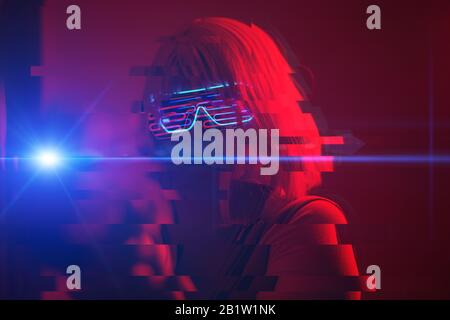 Girl with blaster in the futuristic battle. Concept virtual reality, cyber game and science fiction. Image with glitch effect. Stock Photo