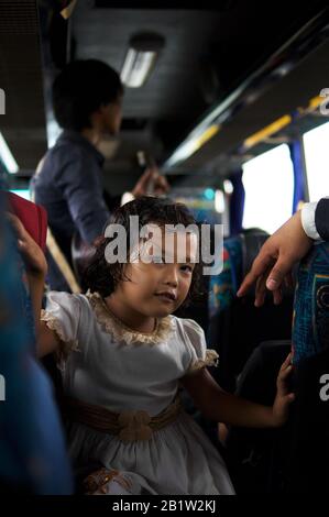 young Indonesian girl and father in bus from Cianjur to Jakarta, Java, Indonesia Stock Photo