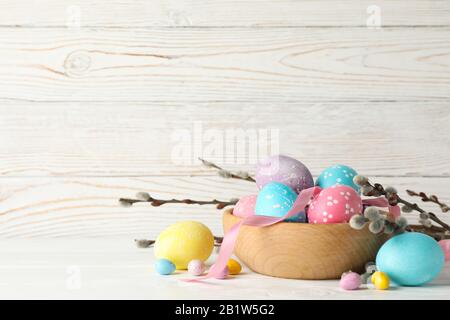 Composition with Easter eggs on white wooden background, space for text Stock Photo