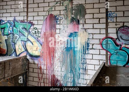 Urban neglected factory, isolated, deserted, forgotten with spray paint graffiti art, bright colours, graffiti artist, urban art Stock Photo