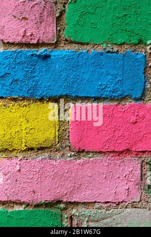 brick wall in different colors painted. Vertical. Close up. Stock Photo