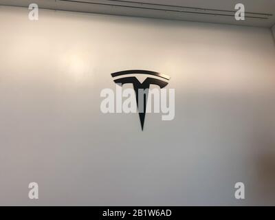 Orlando, FL/USA-2/17/20:  The Tesla logo on the wall at a Tesla retail store.  Tesla is an electric automobile company owned by Elon Musk. Stock Photo