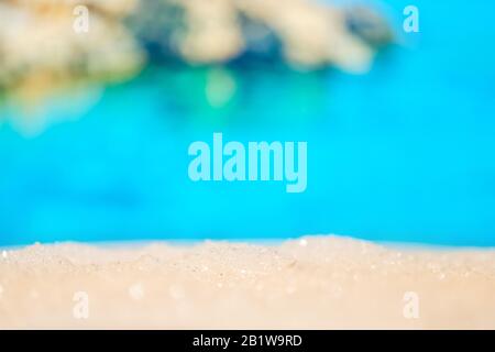 Abstract sand with photo of blurry sea and mountains. Close up. Stock Photo