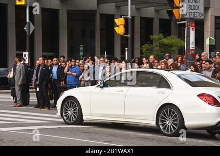 Pedestrians wait to cross a road during rush hour, Toronto, Canada Stock Photo