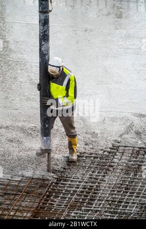 Construction site, concreting, floor, ceiling for a building is concreted, the concrete is pumped onto the reinforced concrete mats, Stock Photo