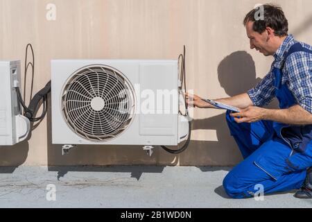 Man Doing Heating, Ventilation, And Air Conditioning Inspection Stock Photo