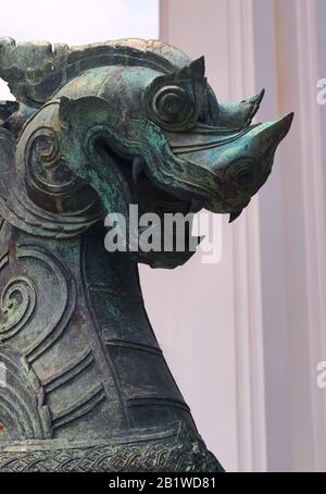 Bronze statue of a Singha guardian lion, one the many leogryphs (lion-like creatures) of asian and buddhist mythology. This one is located in Wat Benc Stock Photo