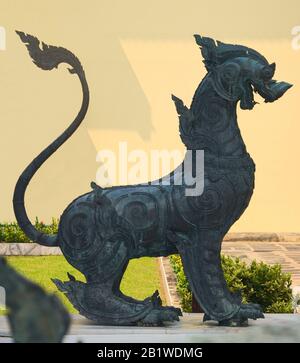 Bronze statue of a Singha guardian lion, one the many leogryphs (lion-like creatures) of asian and buddhist mythology. This one is located in Wat Benc Stock Photo