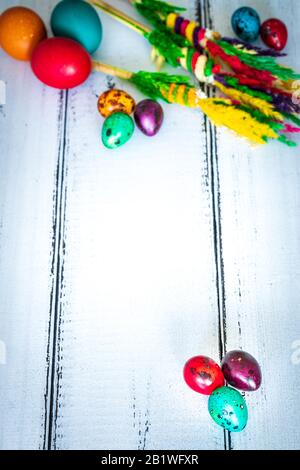 Happy Easter. Traditionally, colorfully painted eggs with decorations on bright, old boards with space for text. Stock Photo