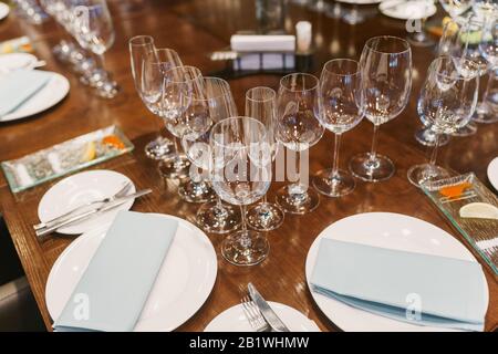 Empty glasses, white plates, cutlery and tableclothes Stock Photo