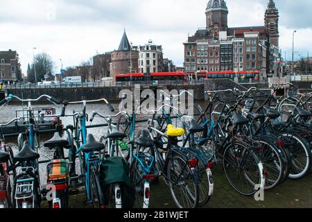 Amsterdam, the Netherlands, 27 February Bikes standing in front of the Basiliek van de Heilige Nicolaas in the Dutch city of Amsterdam Stock Photo