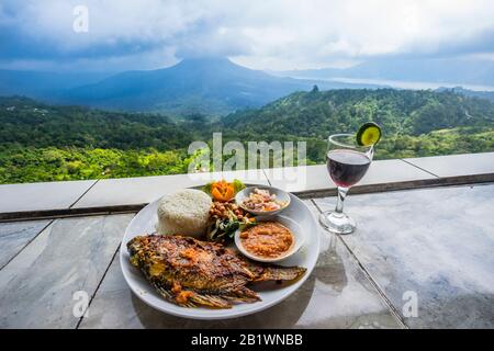 lunch with view of Mount Batur from the volcanic slope of the Batur caldera in Kintamani, Bali, Bangli Regency of Bali, Indonesia Stock Photo