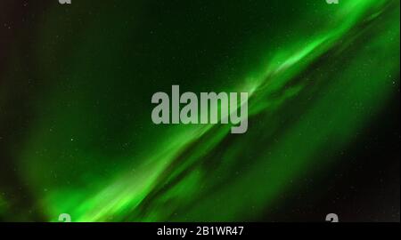 Close up high definition photo of very bright green aurora with stars shining behind it, taken in north Sweden, no clouds, very good for backgrounds Stock Photo