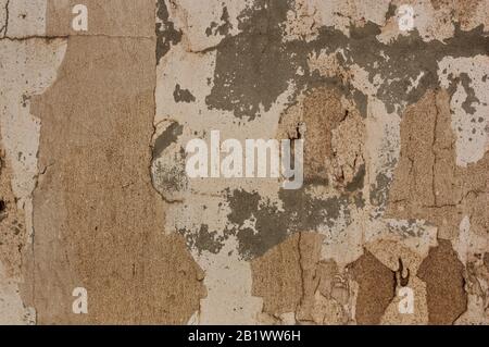 Texture of a wall to which the passage of time has caused the paint to fall giving rise to a background of different colors and textures that gives it Stock Photo