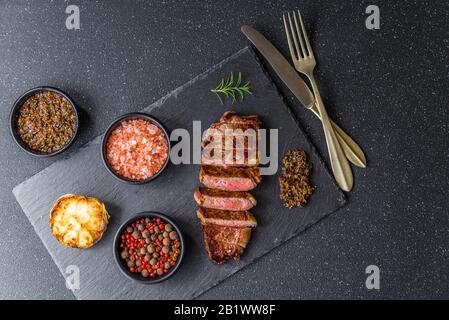 New york strip loin beef steak meat with chimichurri sauce. Stock Photo