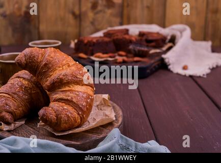 Croissants on a wooden table. Delicious homemade breakfast cakes. Free space for text Stock Photo
