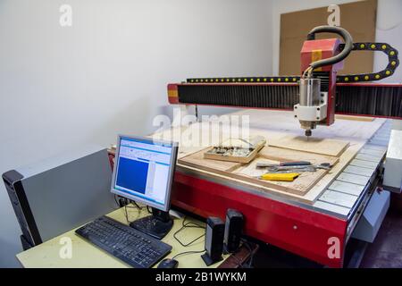 wood milling on modern automatic woodworking machine with CNC. furniture production. Stock Photo