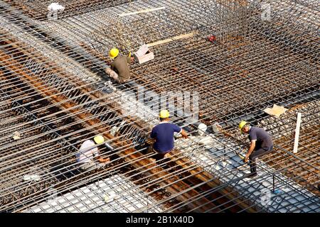 worker in the construction site making reinforcement metal framework ...