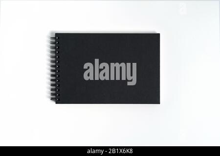 Notebook mock up with clean black blank for design and advertising. Notepad with chromed spring and free copy space template. On the gray background. Stock Photo