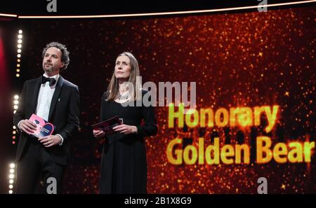 Berlin, Germany. 27th Feb, 2020. Berlinale Executive Director Mariette Rissenbeek (R) and Berlinale Artistic Director Carlo Chatrian attend the award ceremony for the Honorary Golden Bear to actress Helen Mirren during the 70th Berlin International Film Festival in Berlin, capital of Germany, Feb. 27, 2020. Credit: Shan Yuqi/Xinhua/Alamy Live News Stock Photo