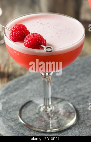 Boozy Pink Clover Club Cocktail with Raspberries Stock Photo