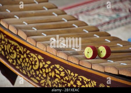 Playing Cambodian traditional musical instrument Kong toch at Wat Phnom ...