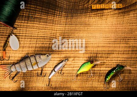 Fishing gear, artificial bait on a predator on a wooden background, top  view wobblers and various bait cords and tongs on a wooden background Stock  Photo - Alamy
