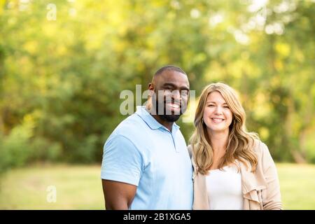 Loving mixed race couple hugging and laughing. Stock Photo