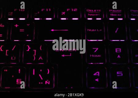 Colorful modern keyboard with rainbow backlight on black background. Backlight of the keyboard in different colors Stock Photo
